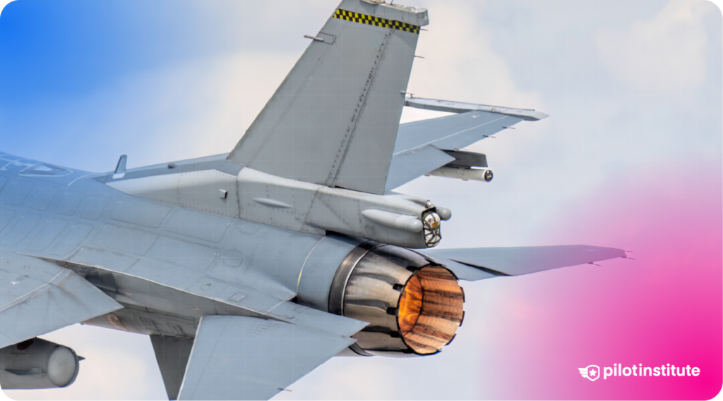 Close-up of the rear of an F-16 fighter jet showing the afterburner in use, with tail surfaces and stabilizers visible.