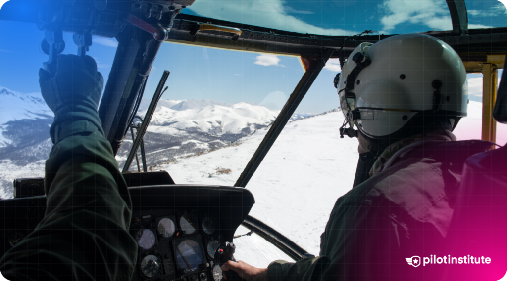 Two pilots in a helicopter cockpit fly over a snowy mountain landscape, with one pilot gripping the cyclic control.