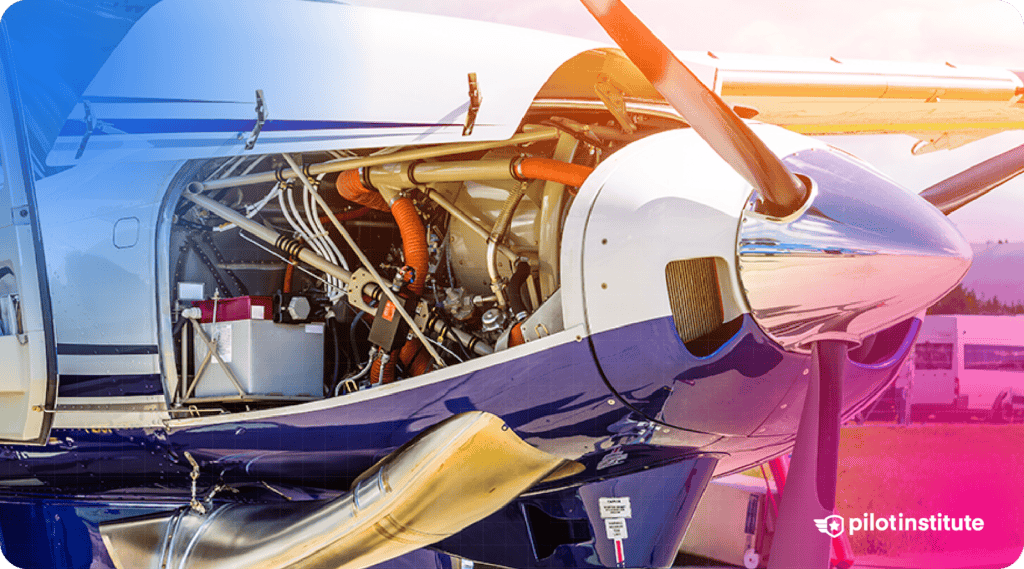 Close-up of a general aviation aircraft engine compartment with the cowl removed, showing internal components like hoses, battery, and propeller assembly.